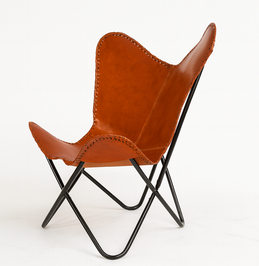 Brown leather butterfly chair with black metal frame on a white background
