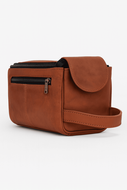 Brown leather bag with a strap on a white background
