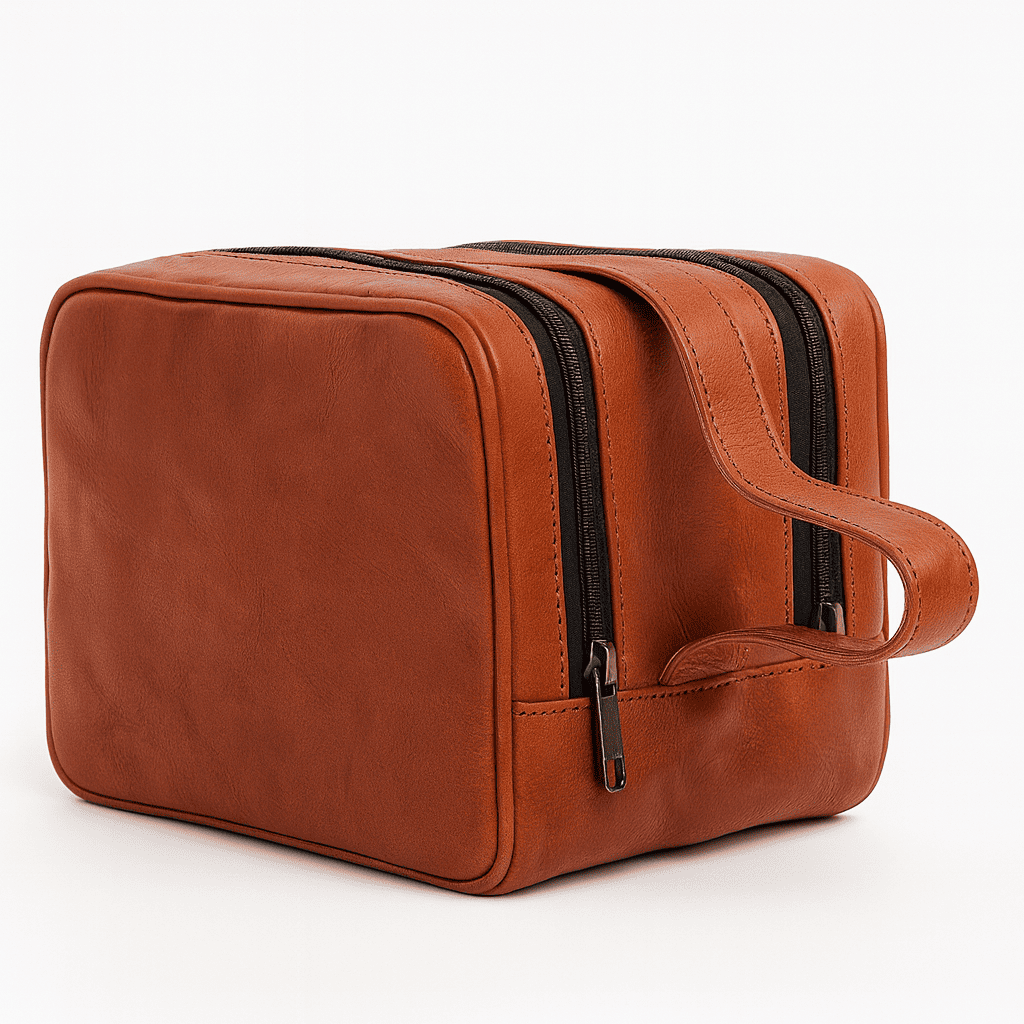 Brown leather toiletry bag with black zipper on a white background