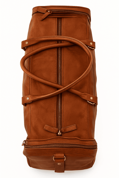 Brown leather duffel bag with gold zippers on a white background

