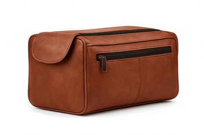 Brown leather toiletry bag with a gold zipper on a white background