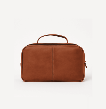 Brown leather toiletry bag on a white background